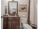 Cozy bathroom featuring a vanity with granite countertop, framed mirror, and neutral paint at 2295 Falmouth Se Ct, Smyrna, GA 30080