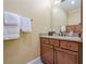 Powder room with granite countertop vanity, framed mirror and soft lighting at 2295 Falmouth Se Ct, Smyrna, GA 30080