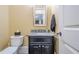 A half bathroom features granite counters, a stylish mirror, and black vanity at 2295 Falmouth Se Ct, Smyrna, GA 30080