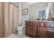 Bathroom with a dark wood vanity with granite countertop and shower with curtain at 2295 Falmouth Se Ct, Smyrna, GA 30080