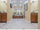 Spacious bathroom with dual sinks, tile floor, arched entryway and vanity at 2295 Falmouth Se Ct, Smyrna, GA 30080
