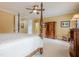 Primary bedroom featuring a four-poster bed, ceiling fan, and shuttered windows at 2295 Falmouth Se Ct, Smyrna, GA 30080