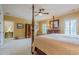 Primary bedroom featuring a four-poster bed, ceiling fan, and shuttered windows at 2295 Falmouth Se Ct, Smyrna, GA 30080