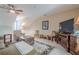 Bright bonus room features plush seating, a ceiling fan, and natural light from the window at 2295 Falmouth Se Ct, Smyrna, GA 30080