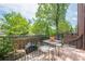 Outdoor deck space with a dining table and chairs, grill, and lush greenery at 2295 Falmouth Se Ct, Smyrna, GA 30080