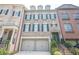 Beautiful townhome showcasing a two-car garage and classic black shutters at 2295 Falmouth Se Ct, Smyrna, GA 30080