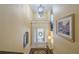 Bright two-story foyer featuring a chandelier and glass-paneled front door at 2295 Falmouth Se Ct, Smyrna, GA 30080