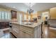 Spacious kitchen featuring a large granite island with a sink and pendant lighting at 2295 Falmouth Se Ct, Smyrna, GA 30080