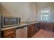 Convenient kitchenette area featuring stainless steel appliances, granite countertops, and custom cabinetry at 2295 Falmouth Se Ct, Smyrna, GA 30080