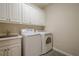 Functional laundry room with a washer, dryer, sink, and ample storage cabinets at 2295 Falmouth Se Ct, Smyrna, GA 30080