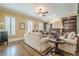 Comfortable living room with hardwood floors, a fireplace, and built-in shelving at 2295 Falmouth Se Ct, Smyrna, GA 30080