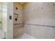Walk-in shower featuring neutral tile work, a built-in bench and shower niche at 2295 Falmouth Se Ct, Smyrna, GA 30080