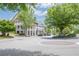 A street view of upscale townhomes with mature landscaping and nearby shops at 2295 Falmouth Se Ct, Smyrna, GA 30080