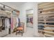Organized walk-in closet with shelves, hanging rods, and a chair at 2295 Falmouth Se Ct, Smyrna, GA 30080