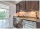 Wet bar featuring upper cabinets and door to outdoor patio at 2295 Falmouth Se Ct, Smyrna, GA 30080