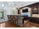 A wet bar features stone accents, wood chairs, and ample cabinet space at 3301 Chastain Ridge Dr, Marietta, GA 30066