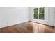 Bright empty bedroom with hardwood floors and large windows that let in natural light at 3301 Chastain Ridge Dr, Marietta, GA 30066