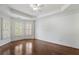 This bedroom has hardwood floors, natural light, and a trey ceiling at 3301 Chastain Ridge Dr, Marietta, GA 30066