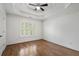 Large bedroom featuring hardwood floors and bright windows with wooden shutters at 3301 Chastain Ridge Dr, Marietta, GA 30066