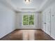 A bright bedroom has wood floors, crown moulding, tray ceiling, and plantation shutters at 3301 Chastain Ridge Dr, Marietta, GA 30066