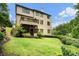 Exterior view of the home with multiple decks, a screened in porch and landscaped backyard at 3301 Chastain Ridge Dr, Marietta, GA 30066