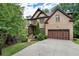 Beautiful brick home showcasing a well-manicured lawn, mature trees, and an attached two-car garage at 3301 Chastain Ridge Dr, Marietta, GA 30066