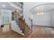 Grand foyer with hardwood floors, staircase with wooden and iron railings, and abundant natural light at 3301 Chastain Ridge Dr, Marietta, GA 30066