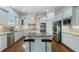 Well-appointed kitchen featuring stainless steel appliances, white cabinetry, granite countertops, and a convenient kitchen island at 3301 Chastain Ridge Dr, Marietta, GA 30066