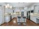 Elegant kitchen featuring white cabinetry, stainless steel appliances, granite countertops, and a functional center island at 3301 Chastain Ridge Dr, Marietta, GA 30066
