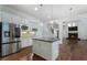 Open kitchen with a center island, granite countertops, stainless steel appliances, and a view into the adjoining living room at 3301 Chastain Ridge Dr, Marietta, GA 30066