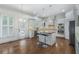 Bright kitchen boasting white cabinets, stainless steel appliances, granite countertops, island seating, and ample natural light at 3301 Chastain Ridge Dr, Marietta, GA 30066