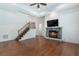 A living room features wood floors, a stone fireplace and staircase at 3301 Chastain Ridge Dr, Marietta, GA 30066
