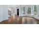 Open-concept living room featuring hardwood floors, large windows, and staircase with iron railing at 3301 Chastain Ridge Dr, Marietta, GA 30066