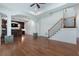 Large living room with hardwood floors, wet bar, and staircase at 3301 Chastain Ridge Dr, Marietta, GA 30066