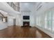 Inviting living room featuring a fireplace, hardwood floors, high ceilings, and large windows with shutters at 3301 Chastain Ridge Dr, Marietta, GA 30066