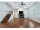 Open living room with fireplace, hardwood floors, and staircase at 3301 Chastain Ridge Dr, Marietta, GA 30066