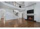 Open living space features a fireplace, hardwood floors, staircase with iron railings and a lofted area at 3301 Chastain Ridge Dr, Marietta, GA 30066