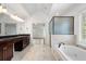 This main bathroom offers double sinks, granite counters, and a glass shower and tub combination at 3301 Chastain Ridge Dr, Marietta, GA 30066