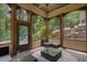 Relaxing screened porch with comfortable seating, a ceiling fan, and views of the backyard at 3301 Chastain Ridge Dr, Marietta, GA 30066