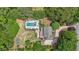 Aerial view highlighting the pool, backyard, and home nestled among trees and landscaping at 4135 Creekwood Dr, Cumming, GA 30041