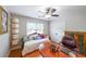 Cozy bedroom featuring a daybed with colorful pillows and a ceiling fan at 4135 Creekwood Dr, Cumming, GA 30041