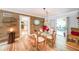 Well-lit dining room boasts hardwood floors, wood accent wall and access to patio at 4135 Creekwood Dr, Cumming, GA 30041