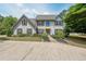Inviting two-story home with a well-manicured lawn and charming curb appeal with shuttered windows at 4135 Creekwood Dr, Cumming, GA 30041