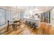 Open-concept kitchen and dining area with modern lighting, stainless steel appliances, and hardwood floors at 4135 Creekwood Dr, Cumming, GA 30041