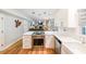 Modern kitchen with stainless steel appliances, white cabinetry, a kitchen island, and hardwood floors at 4135 Creekwood Dr, Cumming, GA 30041