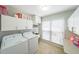 Functional laundry room featuring a washer, dryer, and storage cabinets at 4135 Creekwood Dr, Cumming, GA 30041