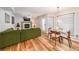 Bright living room flows to dining area, featuring hardwood floors and a fireplace at 4135 Creekwood Dr, Cumming, GA 30041