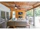 Cozy covered patio with comfortable seating, a ceiling fan, and a mounted TV for outdoor entertainment at 4135 Creekwood Dr, Cumming, GA 30041