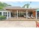 Relaxing covered patio with hanging chairs, a dining table, and comfortable seating area with a TV at 4135 Creekwood Dr, Cumming, GA 30041
