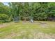 Backyard with a playground, including a swing set, slide, and trampoline at 4135 Creekwood Dr, Cumming, GA 30041